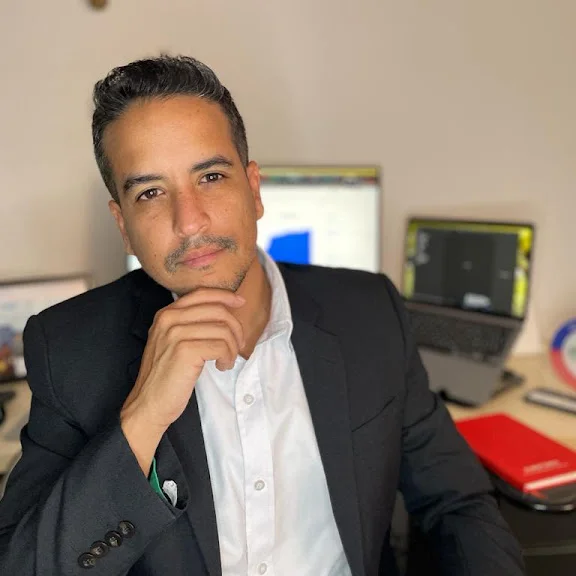 Professional portrait of Juan Carlos Cadavid Ruiz in a workspace setting